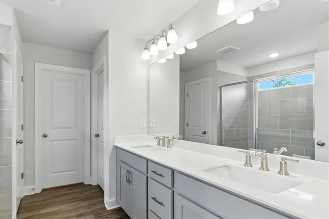 a bathroom with a sink double vanity and a mirror