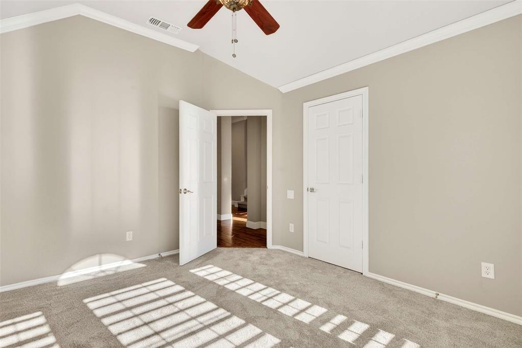 704 Scenic Ranch Circle Fairview, TX 75069 - Photo 19 of 40 a view of a bedroom with a bed and wooden floor
