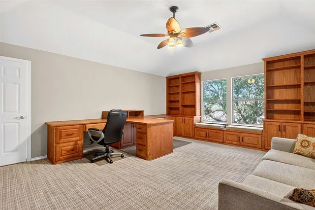 a livingroom with workspace and a window
