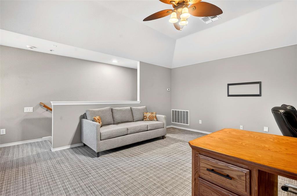 704 Scenic Ranch Circle Fairview, TX 75069 - Photo 24 of 40 a living room with furniture and a chandelier