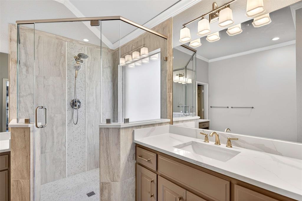 704 Scenic Ranch Circle Fairview, TX 75069 - Photo 26 of 40 a bathroom with a sink vanity granite shower and a mirror