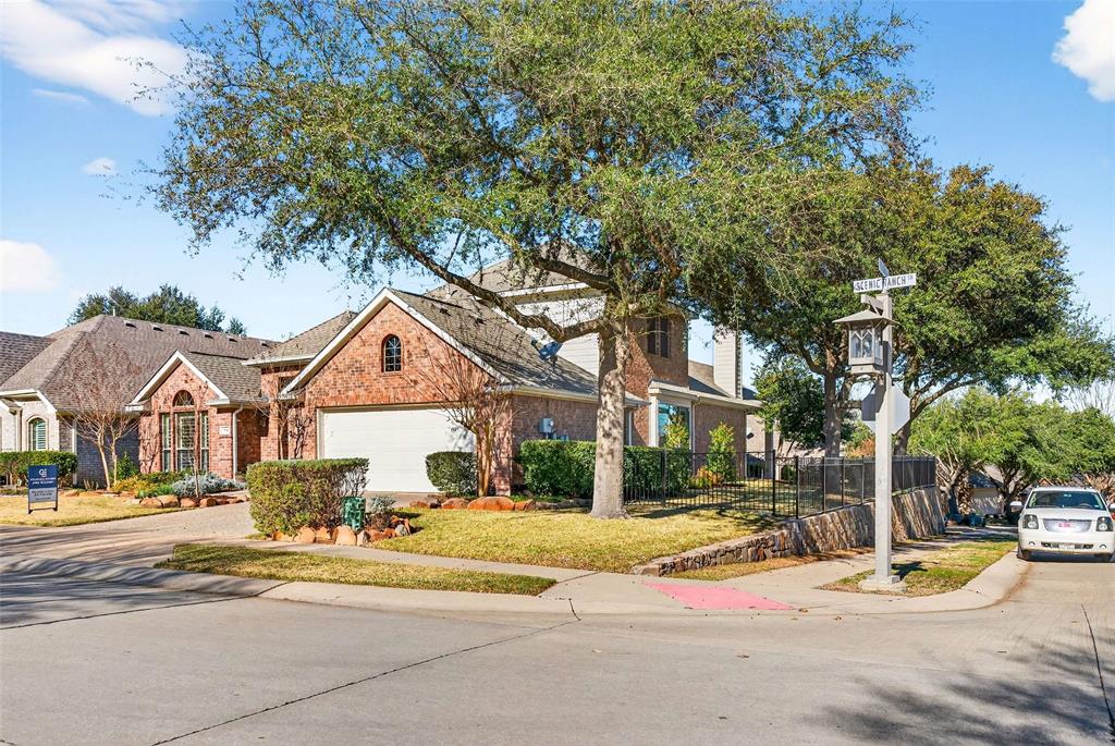 704 Scenic Ranch Circle Fairview, TX 75069 - Photo 3 of 40 a front view of a house with a garden