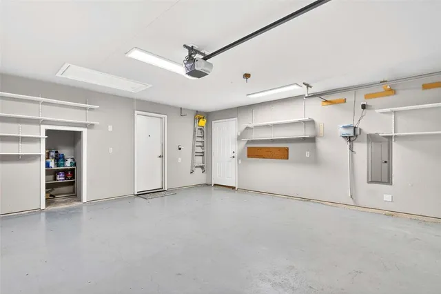 an empty room with ceiling fan and windows