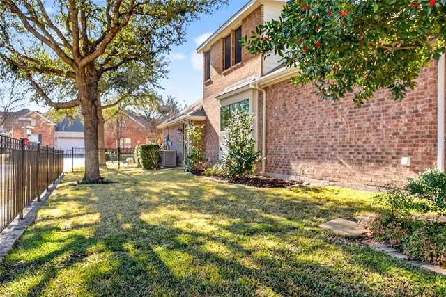 a view of a house with a yard and tree s