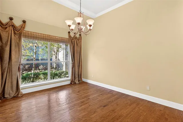 a view of a room with wooden floor chandelier and mountain view