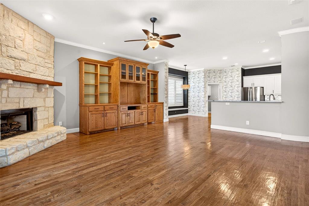 704 Scenic Ranch Circle Fairview, TX 75069 - Photo 9 of 40 a view of a livingroom with wooden floor and a kitchen
