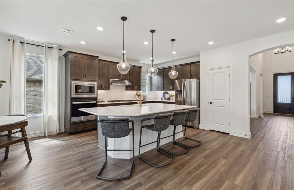 4708 Ripley Court Celina, TX 75009 - Photo 5 of 18 *Model Representation - Spacious kitchen with eat-in bartop island