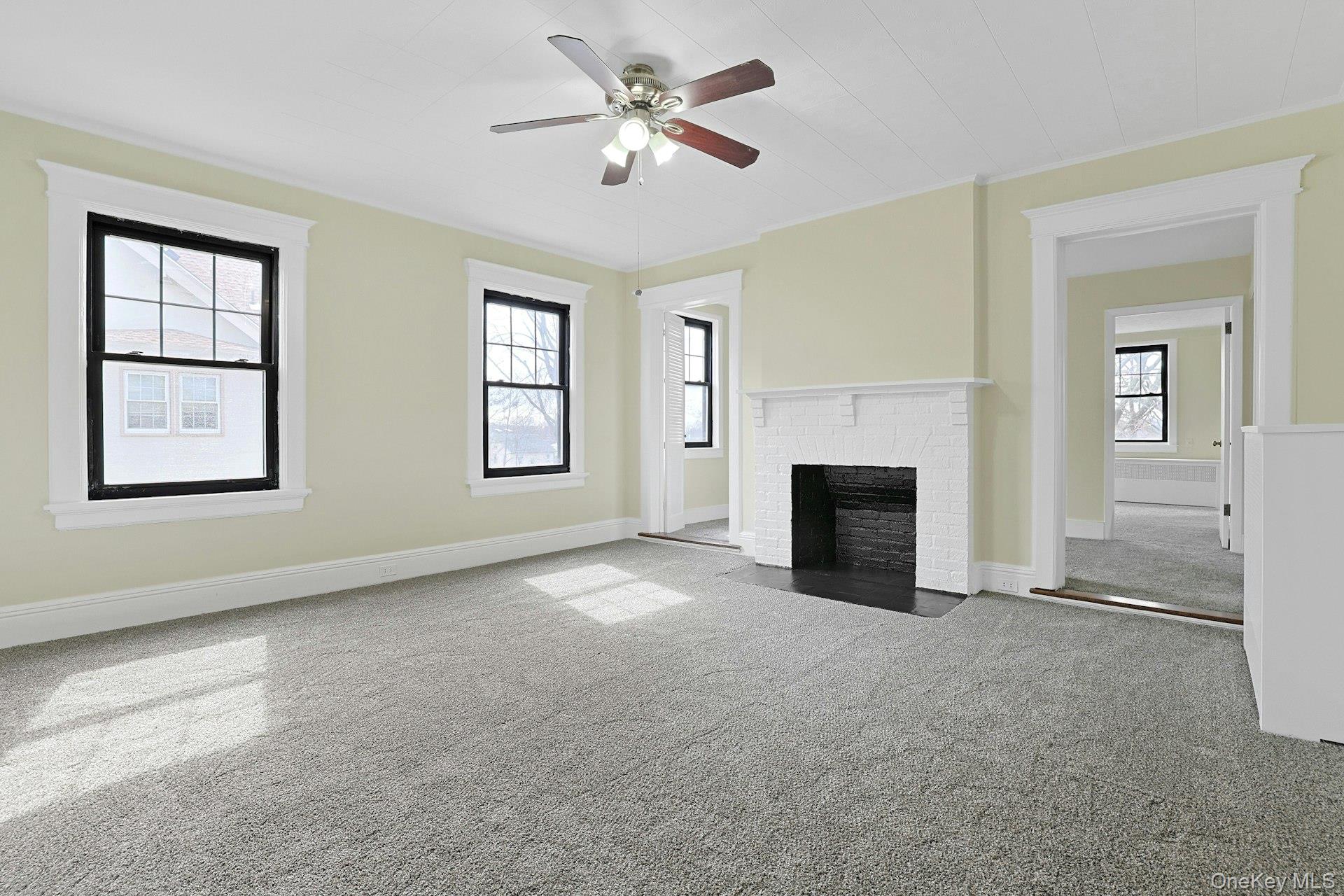 39 Neptune Avenue New Rochelle, NY 10805 - Photo 12 of 28 an empty room with windows and fireplace