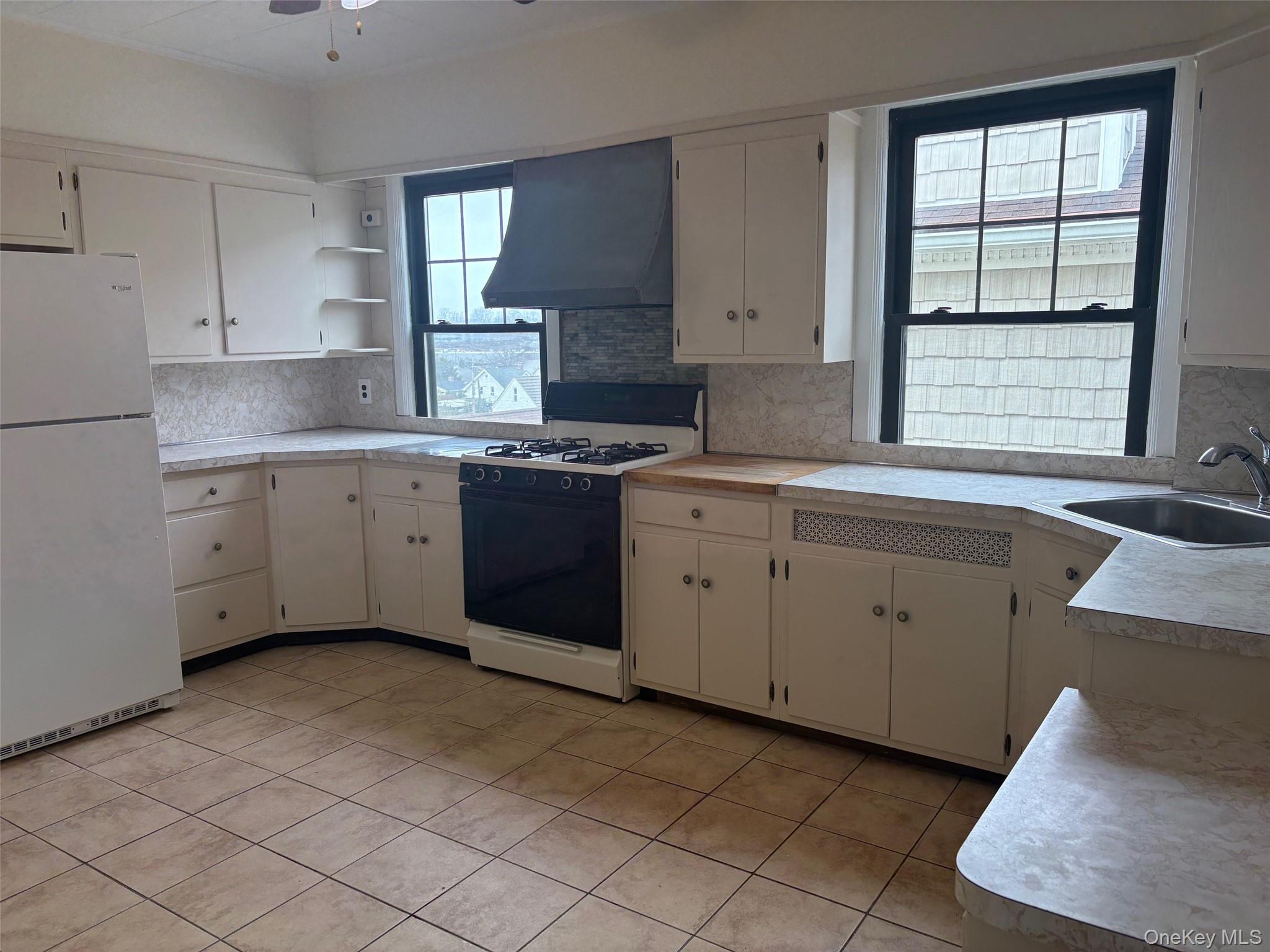 39 Neptune Avenue New Rochelle, NY 10805 - Photo 15 of 28 a kitchen that has a sink and a stove in it