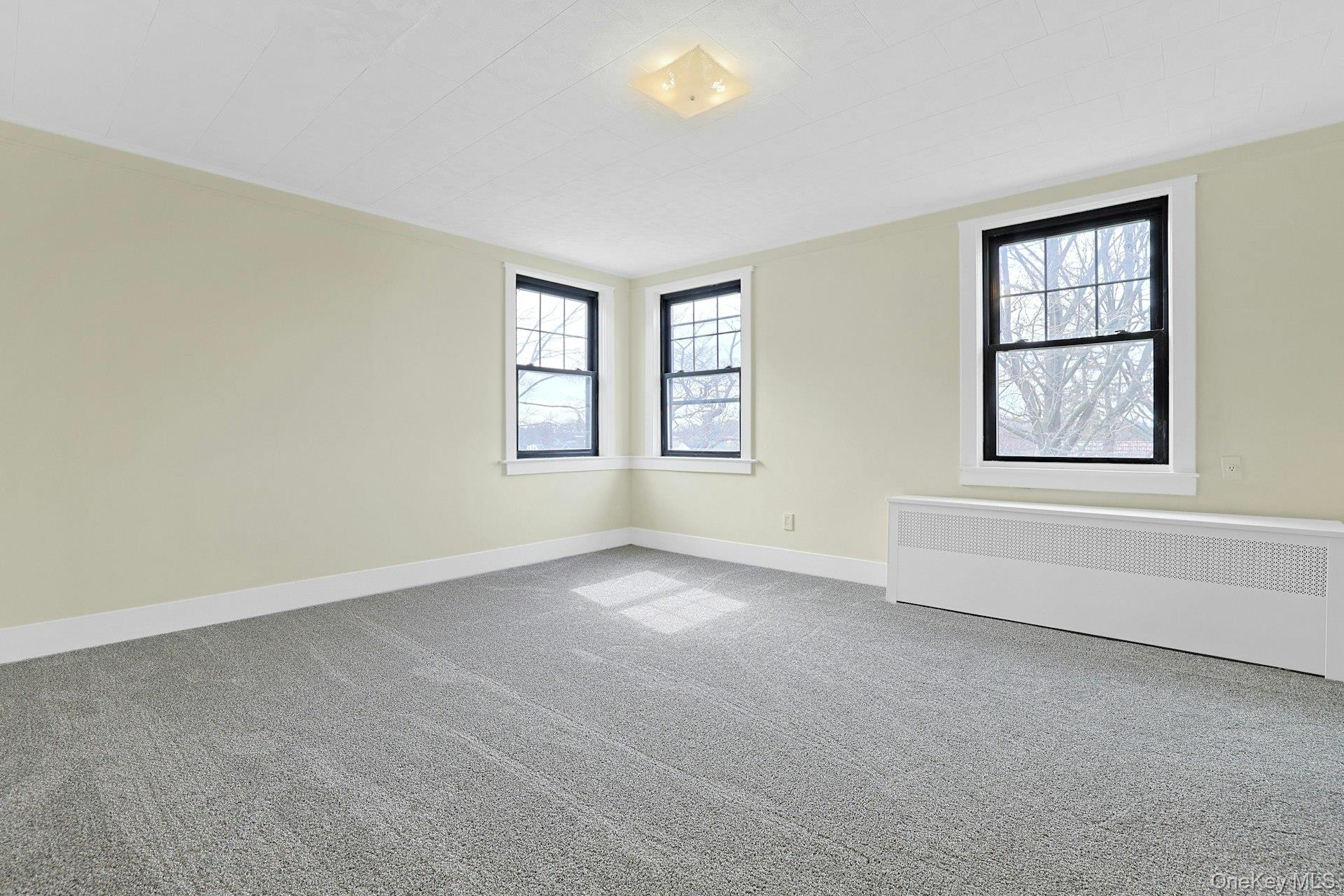 39 Neptune Avenue New Rochelle, NY 10805 - Photo 16 of 28 an empty room with windows and closet