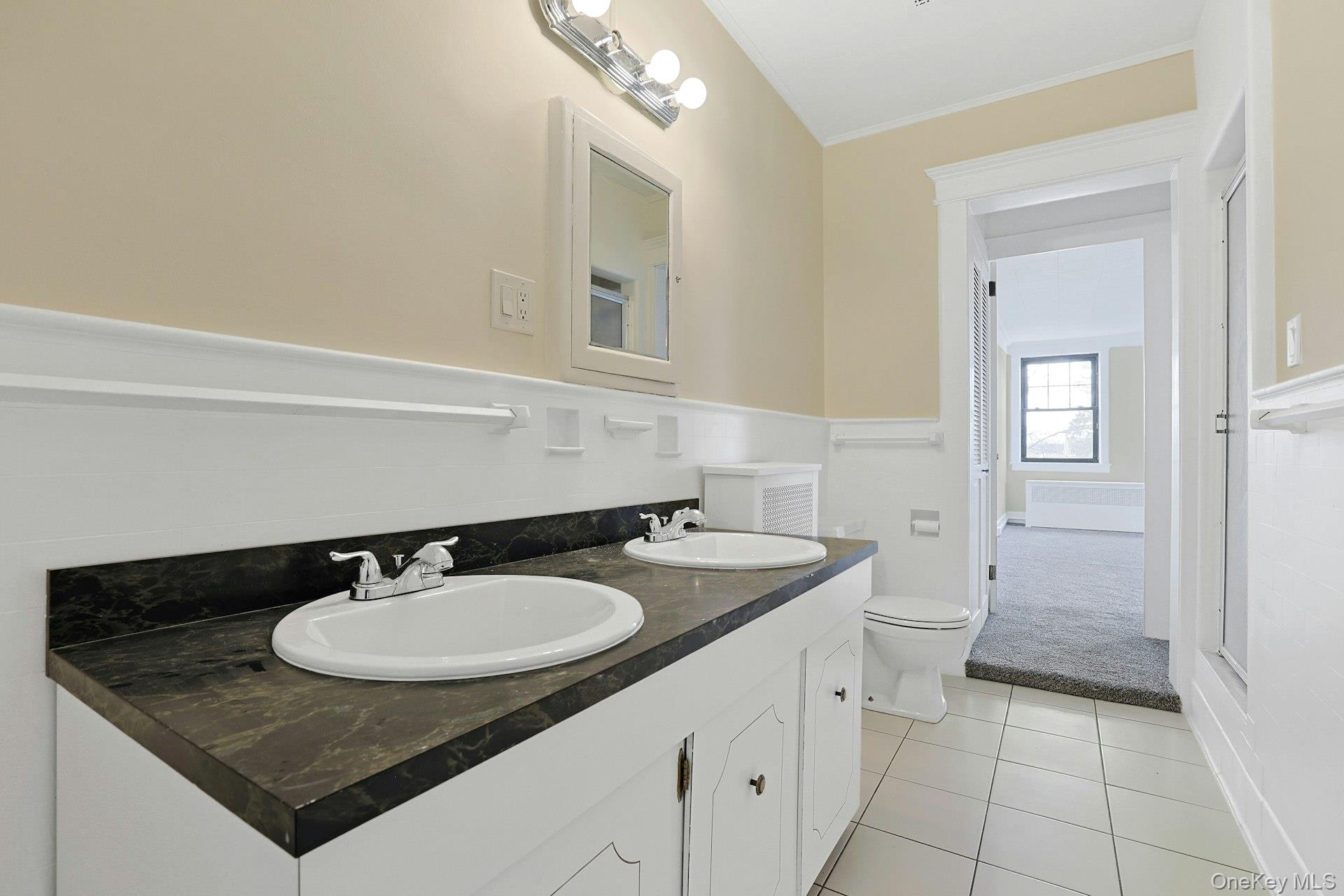 39 Neptune Avenue New Rochelle, NY 10805 - Photo 17 of 28 a bathroom with a sink a toilet and mirror