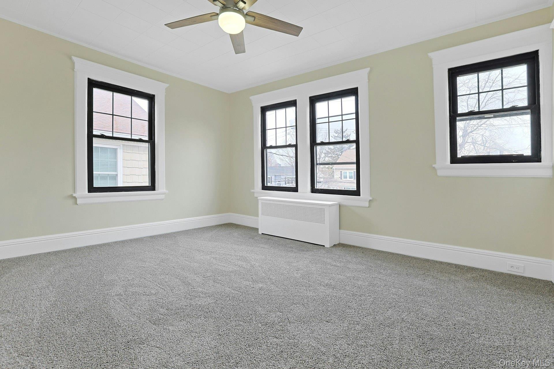 39 Neptune Avenue New Rochelle, NY 10805 - Photo 18 of 28 an empty room with windows and fan