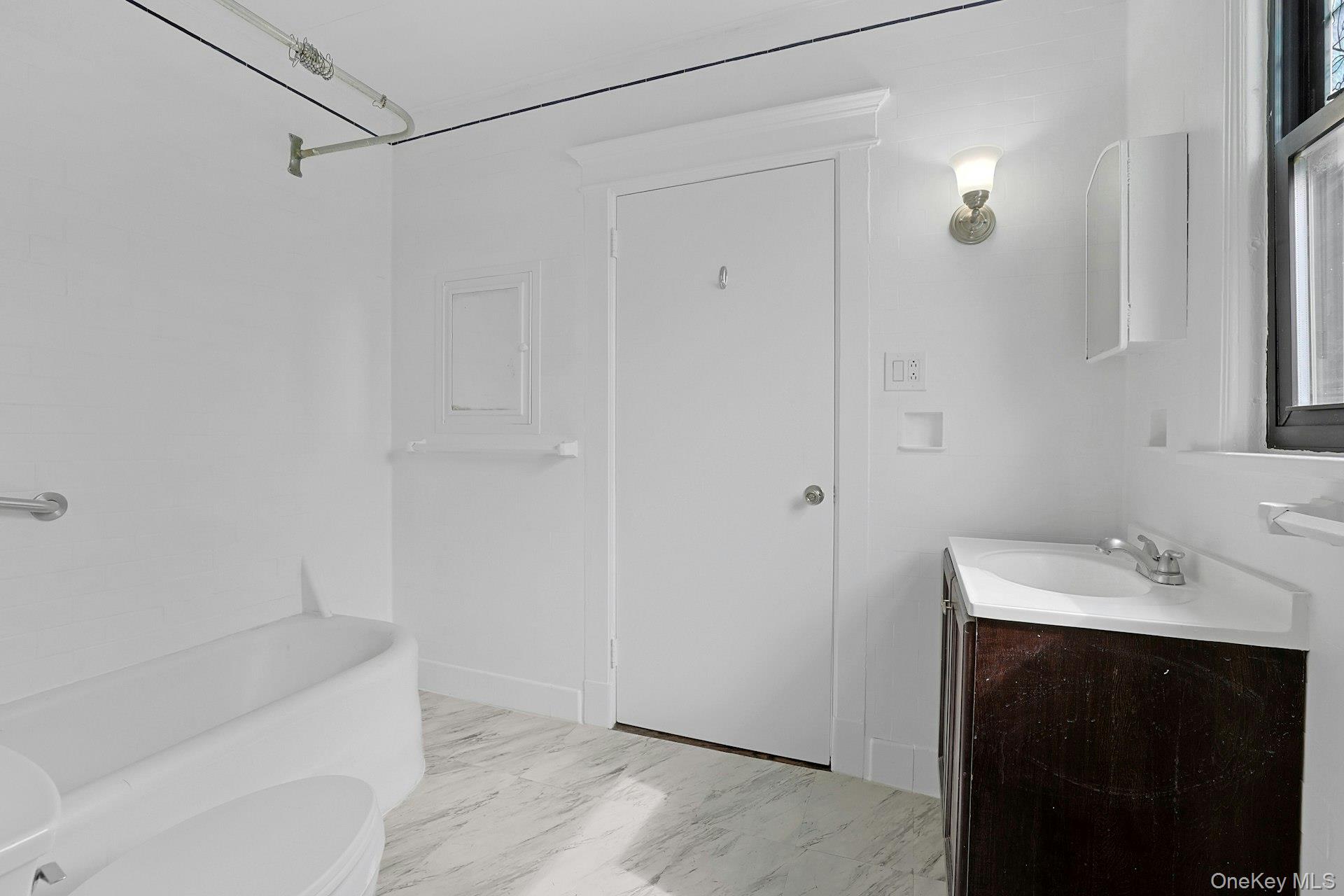 39 Neptune Avenue New Rochelle, NY 10805 - Photo 21 of 28 a bathroom with a sink and shower