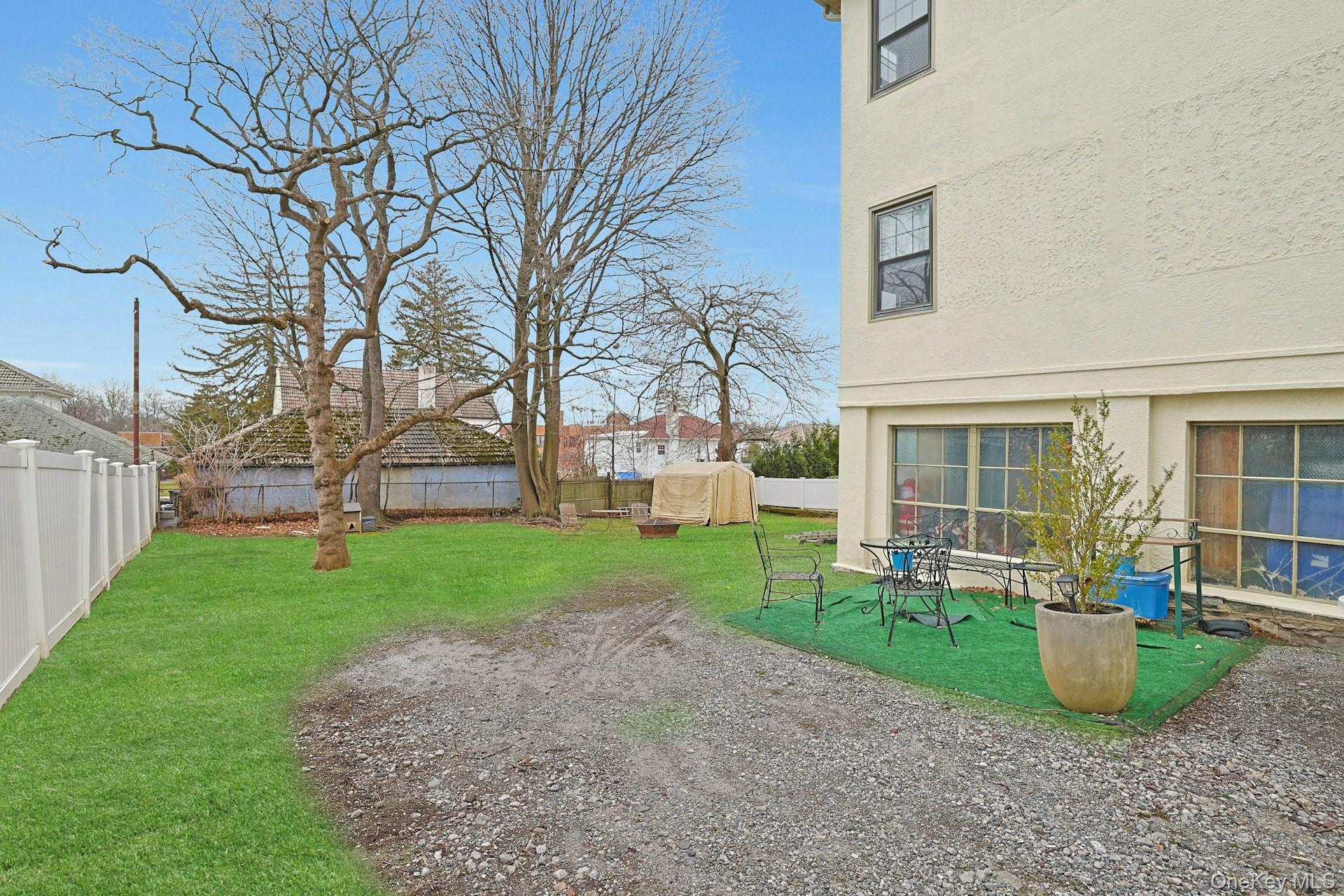 39 Neptune Avenue New Rochelle, NY 10805 - Photo 22 of 28 a view of a house with backyard porch and garden