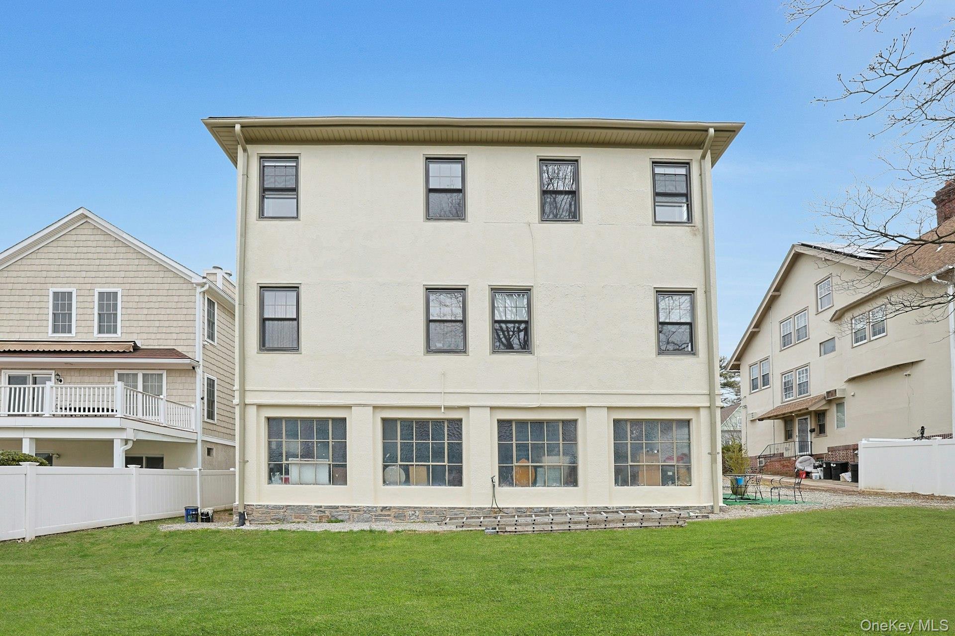 39 Neptune Avenue New Rochelle, NY 10805 - Photo 23 of 28 a front view of a house with a yard