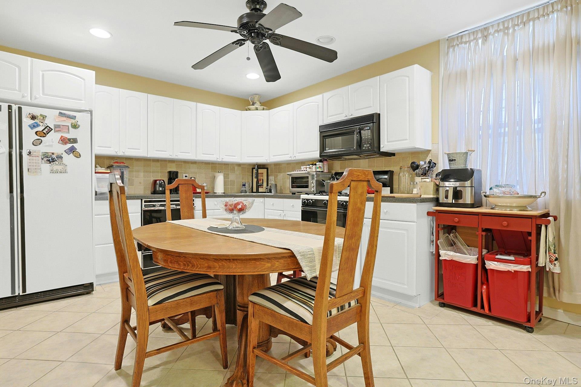 39 Neptune Avenue New Rochelle, NY 10805 - Photo 6 of 28 a view of a dining room with furniture and a chandelier