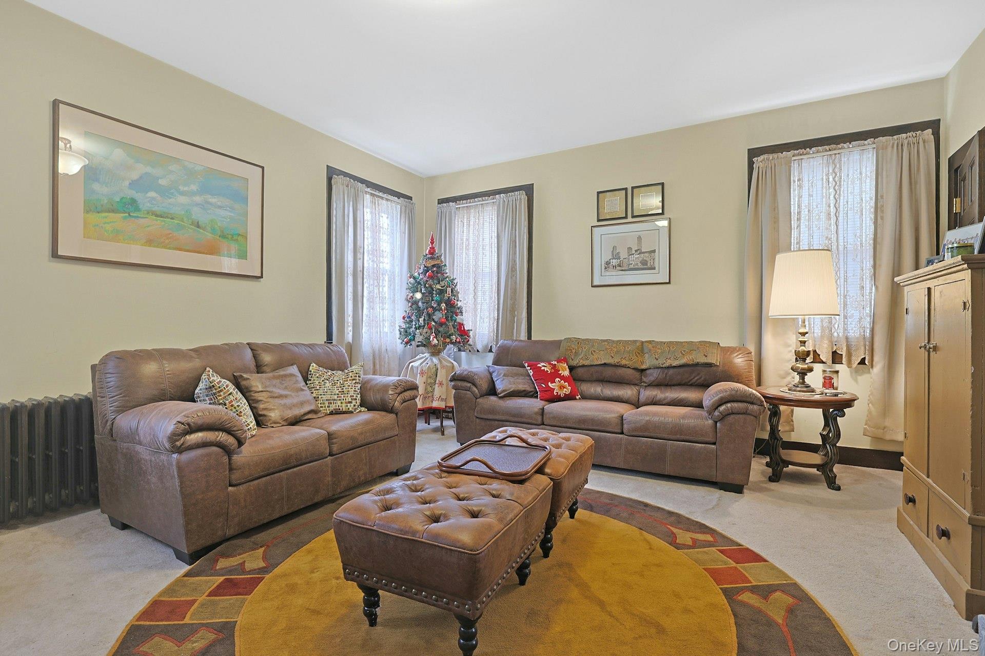 39 Neptune Avenue New Rochelle, NY 10805 - Photo 10 of 28 a living room with furniture a rug and a lamp