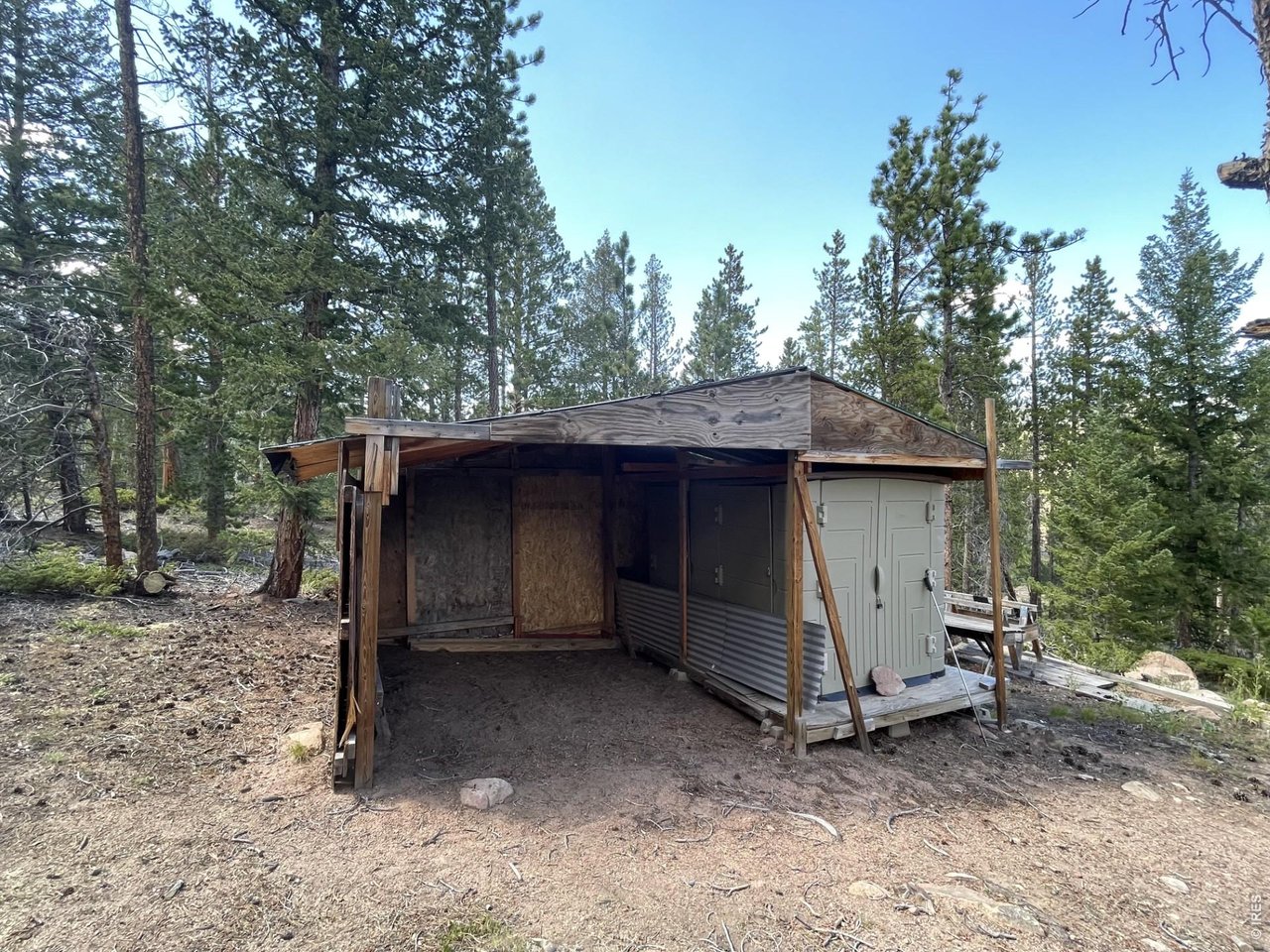 34 Shawnee Road Red Feather Lakes, CO 80545 - Photo 12 of 31 Storage shed has open area for ATV/UTV storage & locked, secure storage.