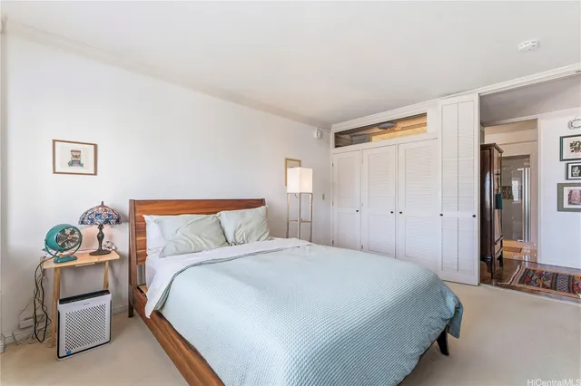 a bedroom with a bed and a couch