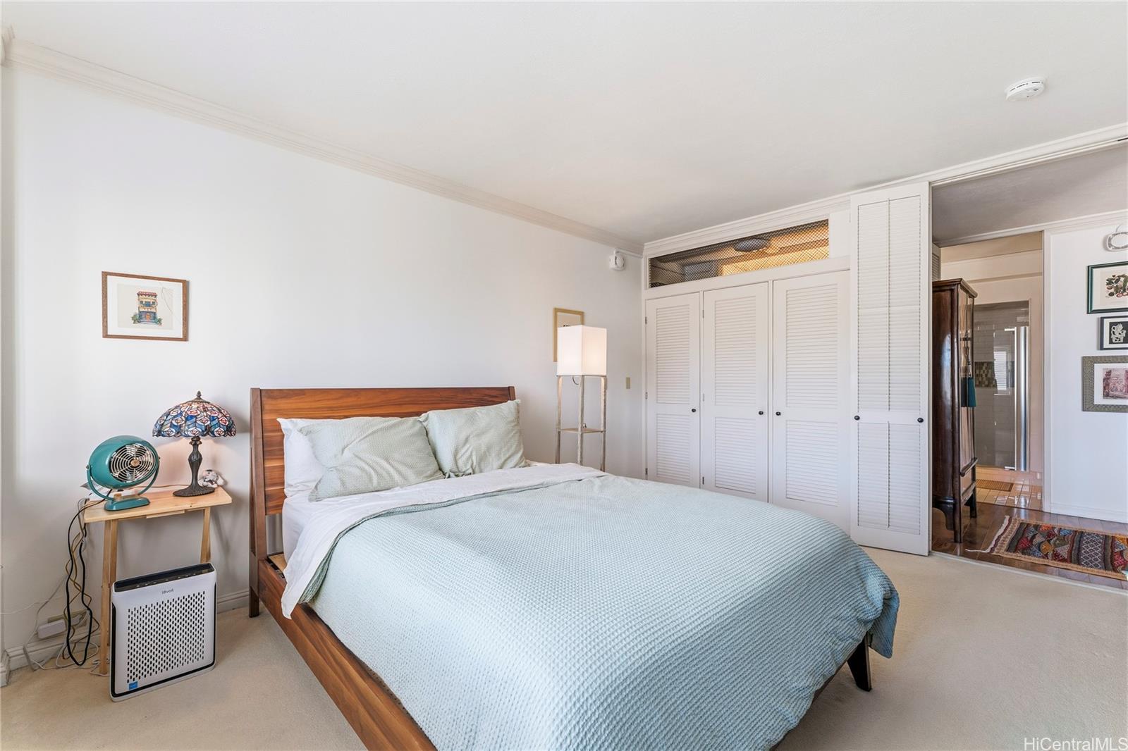 1001 Wilder Avenue, Unit 602 Honolulu, HI 96822 - Photo 11 of 22 a bedroom with a bed and a couch