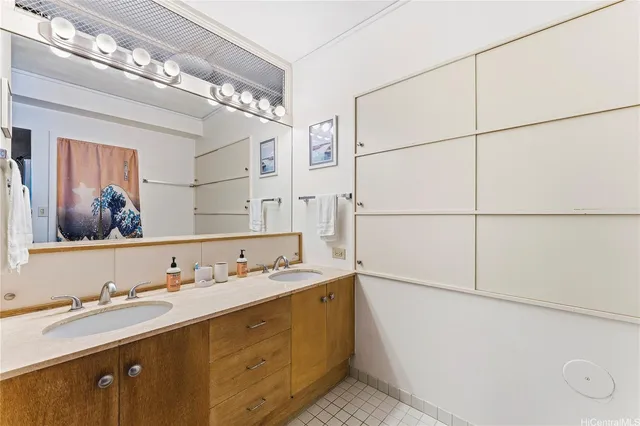 a bathroom with a double vanity sink and a mirror