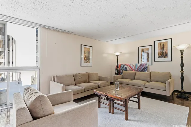 a living room with furniture a rug and a window