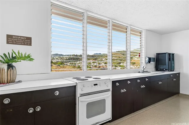 a kitchen with a sink and large window