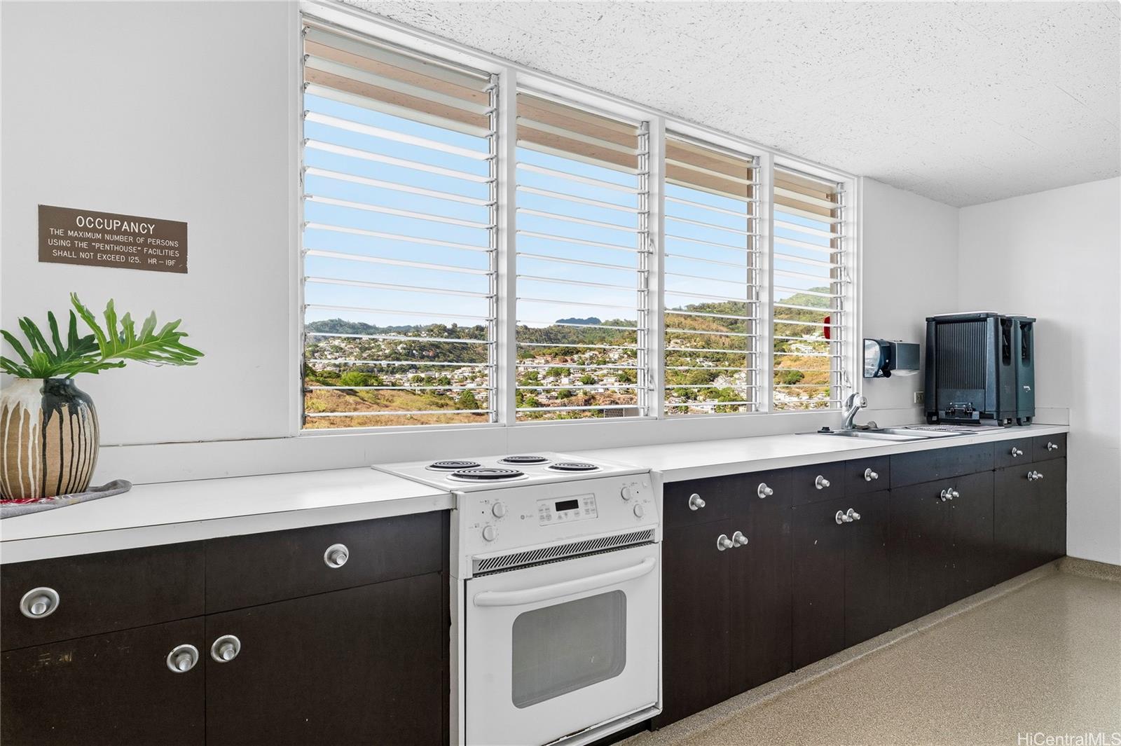 1001 Wilder Avenue, Unit 602 Honolulu, HI 96822 - Photo 20 of 22 a kitchen with a sink and large window