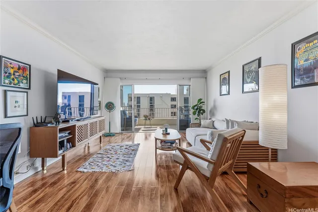 a living room with furniture and a wooden floor