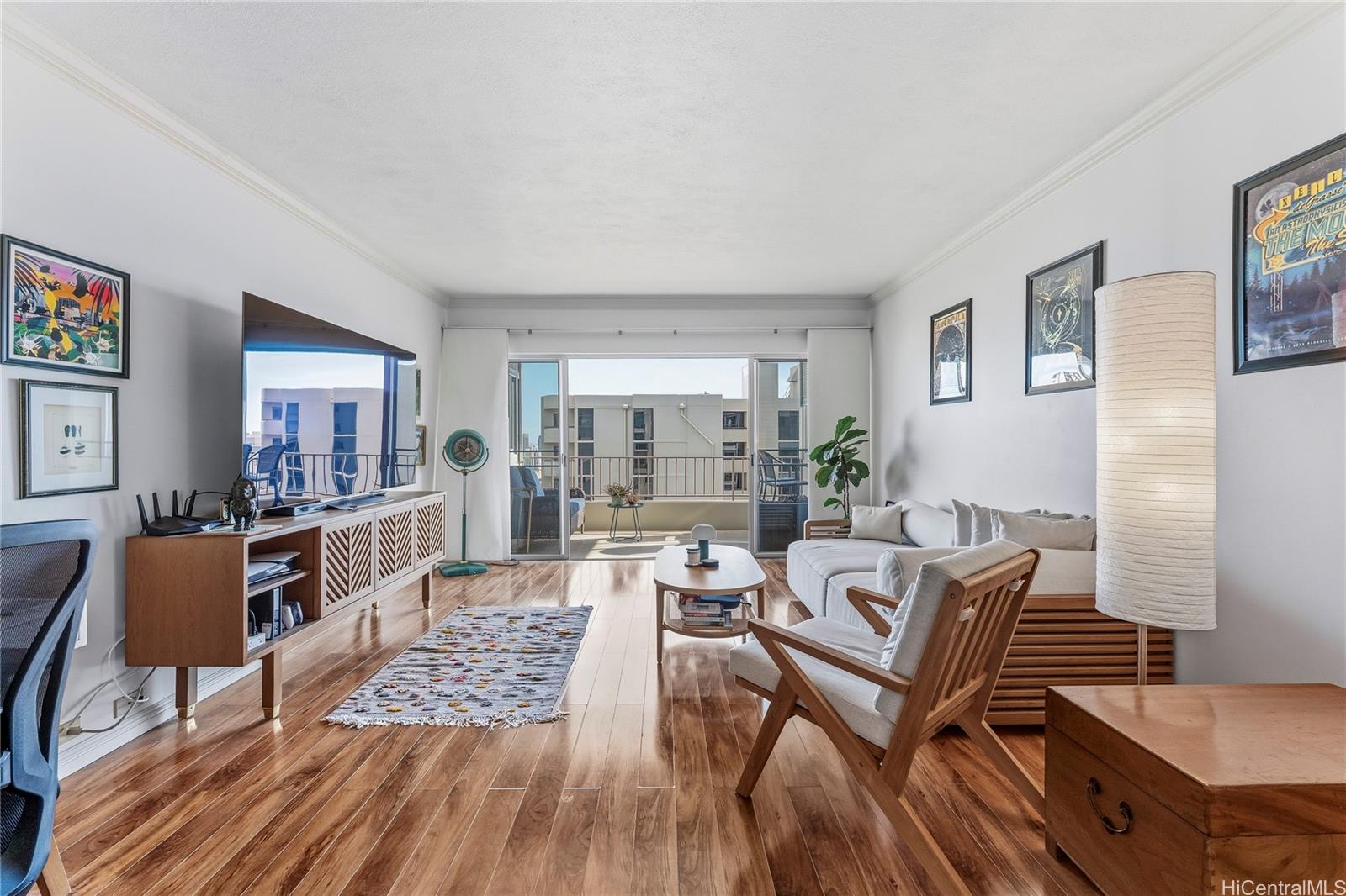 1001 Wilder Avenue, Unit 602 Honolulu, HI 96822 - Photo 2 of 22 a living room with furniture and a wooden floor