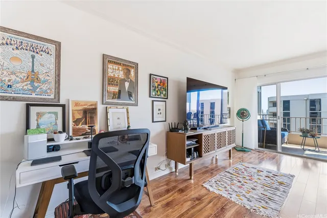 a view of a livingroom with furniture window and wooden floor
