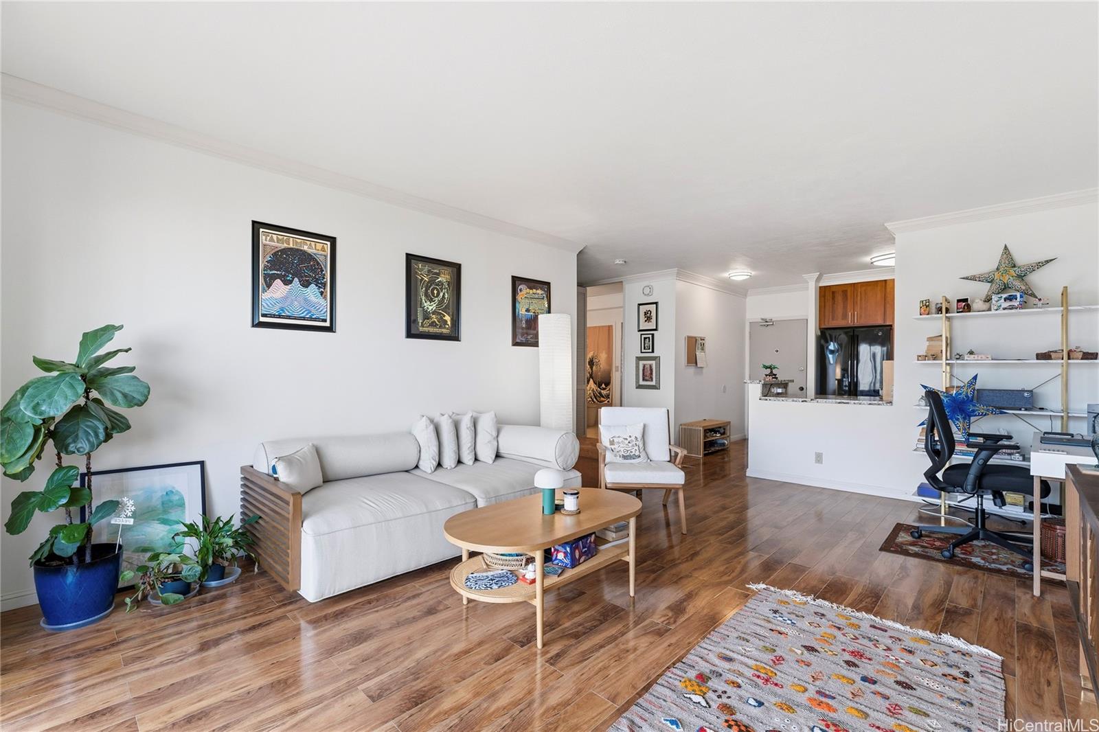 1001 Wilder Avenue, Unit 602 Honolulu, HI 96822 - Photo 4 of 22 a living room with furniture and a wooden floor