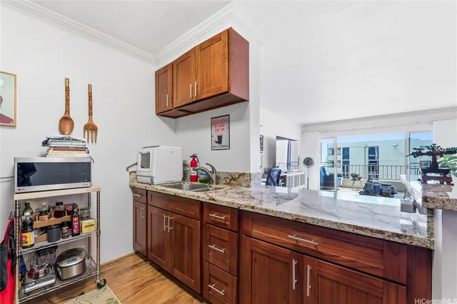 a kitchen with stainless steel appliances granite countertop a sink stove and cabinets