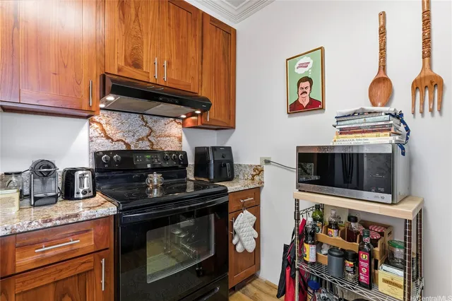 a kitchen with stainless steel appliances granite countertop a stove and a sink