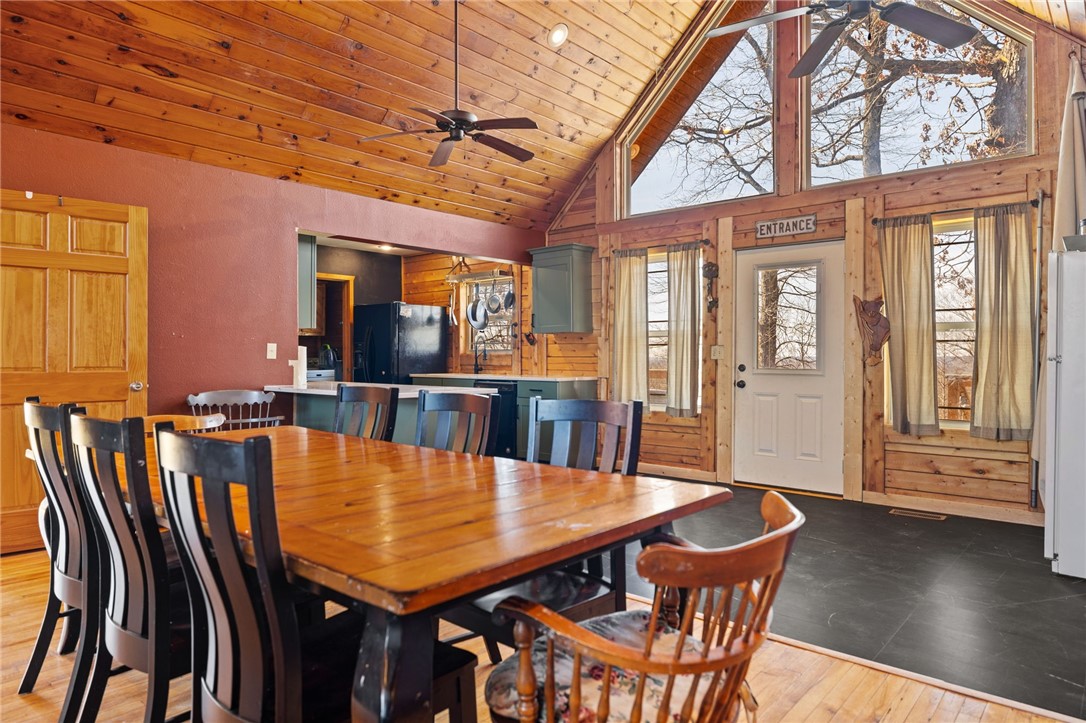 10557 North Devils Den Road Winslow, AR 72959 - Photo 10 of 60 Dining area featuring ceiling fan, a high wooden ceiling, and light wood-type flooring