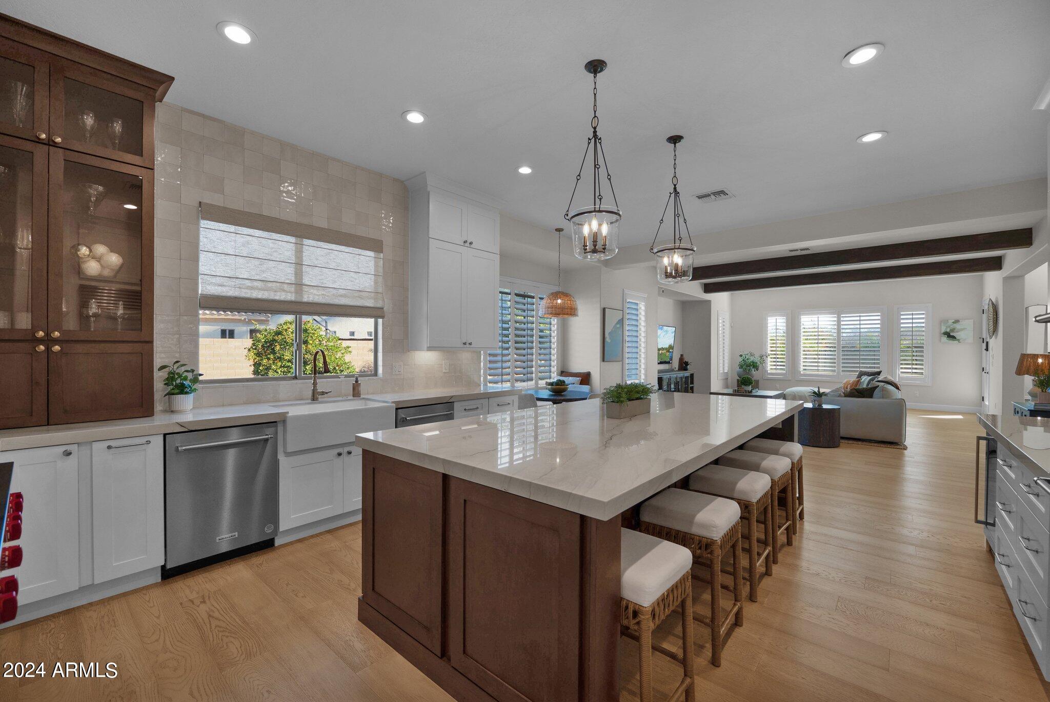 2517 South Constellation Way Gilbert, AZ 85295 - Photo 29 of 105 a kitchen with center island a sink stainless steel appliances and cabinets