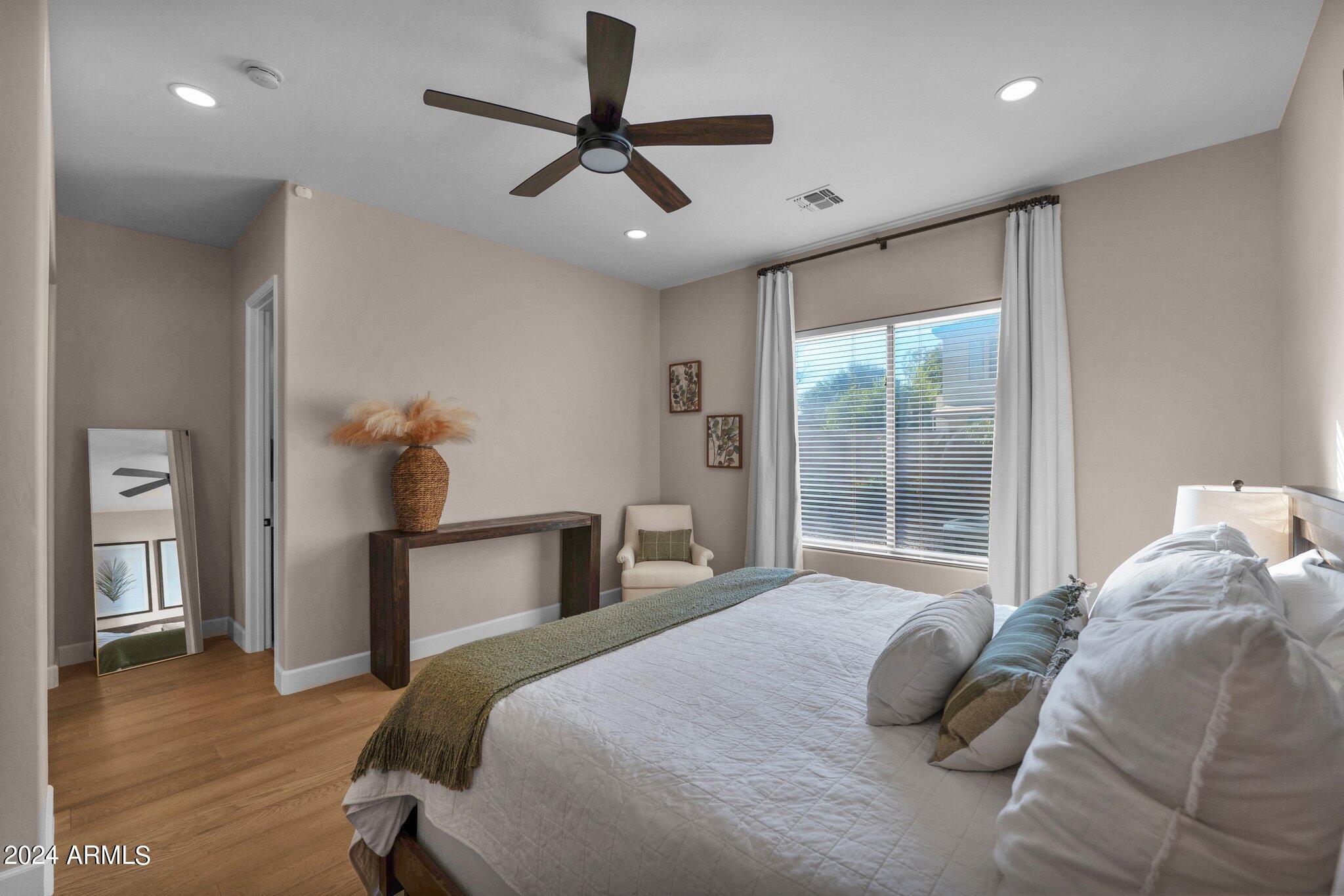 2517 South Constellation Way Gilbert, AZ 85295 - Photo 36 of 105 a bedroom with a bed and a chandelier