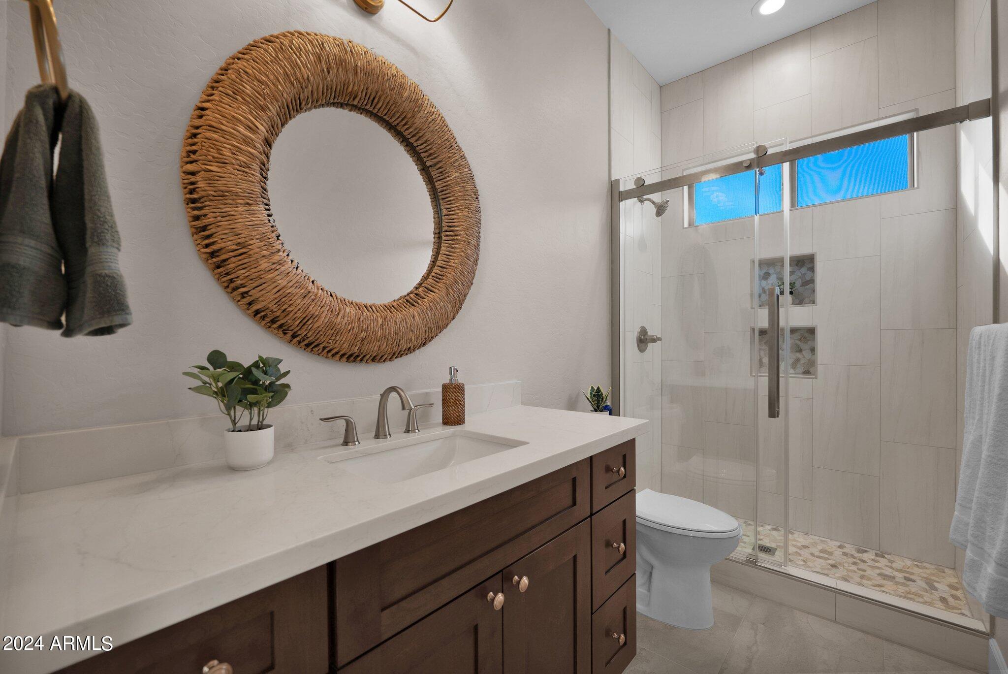 2517 South Constellation Way Gilbert, AZ 85295 - Photo 37 of 105 a bathroom with a granite countertop sink mirror toilet and shower