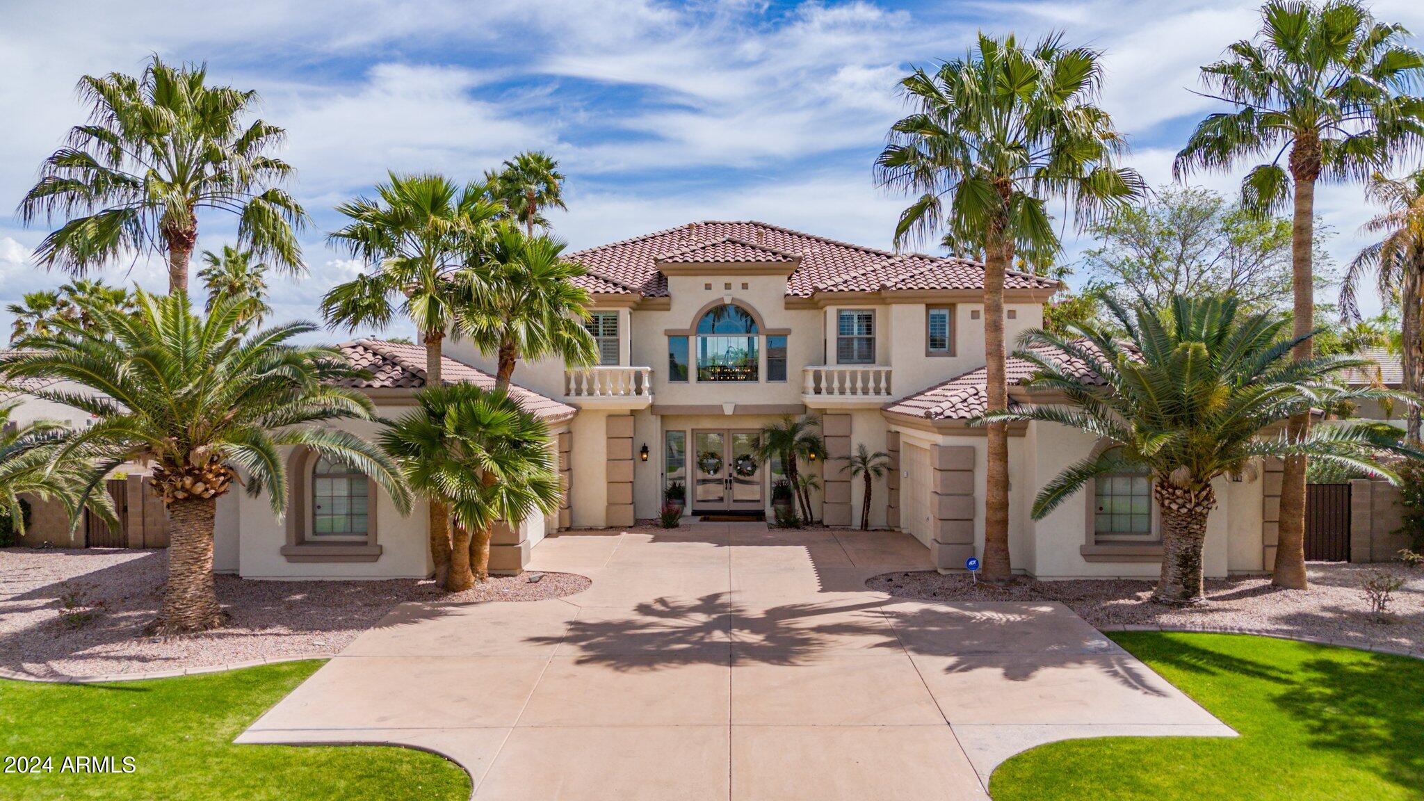 2517 South Constellation Way Gilbert, AZ 85295 - Photo 4 of 105 a front view of a house with a yard and palm trees