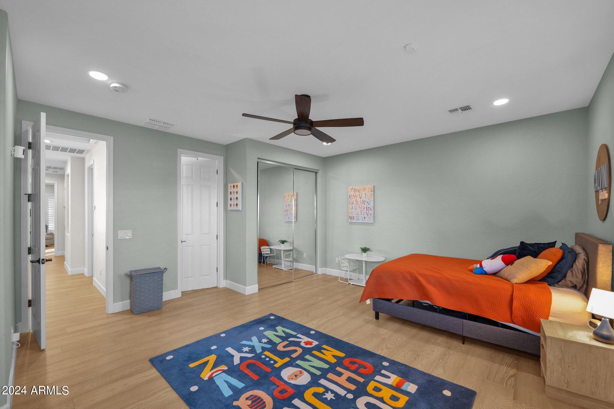 2517 South Constellation Way Gilbert, AZ 85295 - Photo 56 of 105 a bedroom with a bed and a chandelier