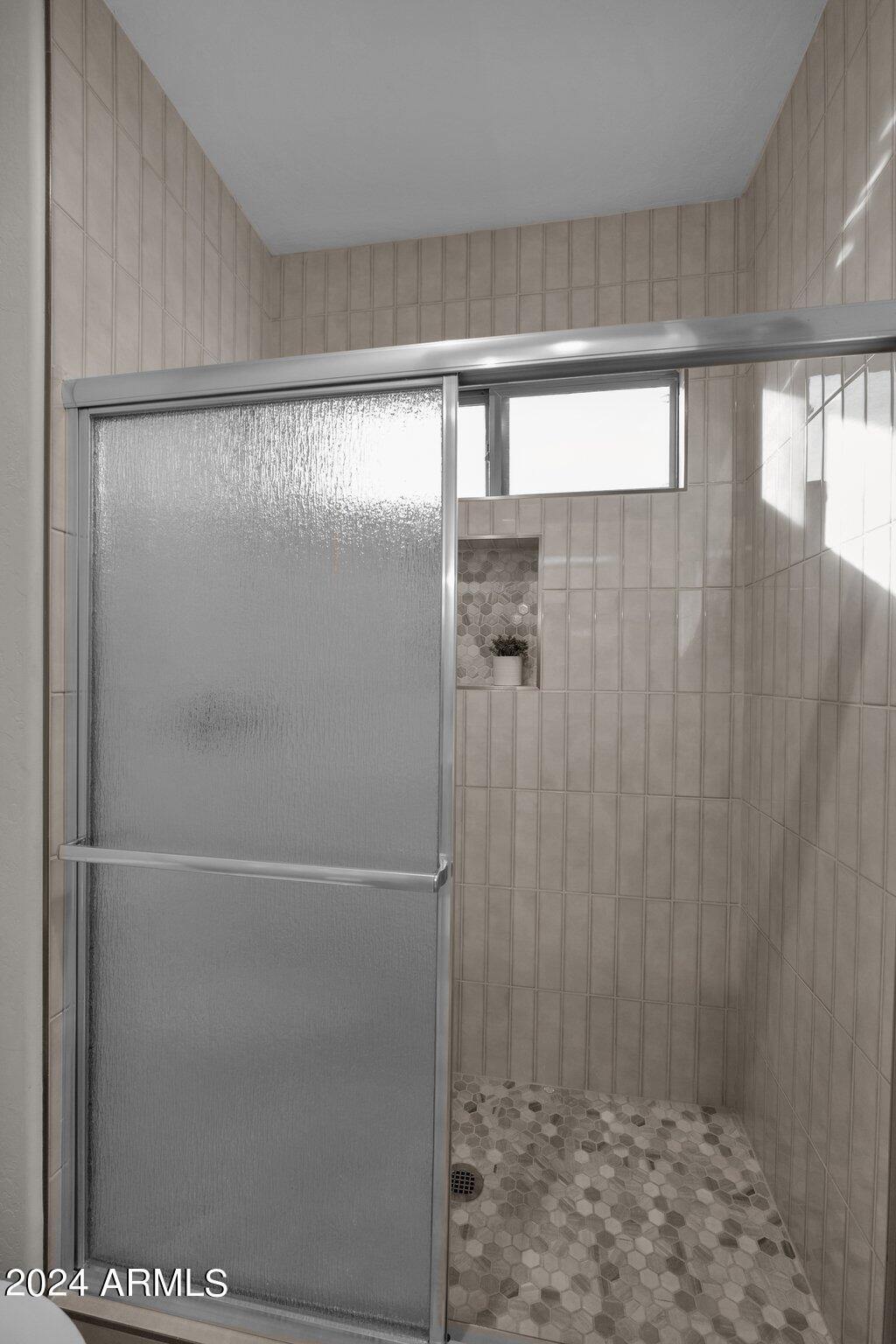 2517 South Constellation Way Gilbert, AZ 85295 - Photo 59 of 105 a bathroom with a glass shower door