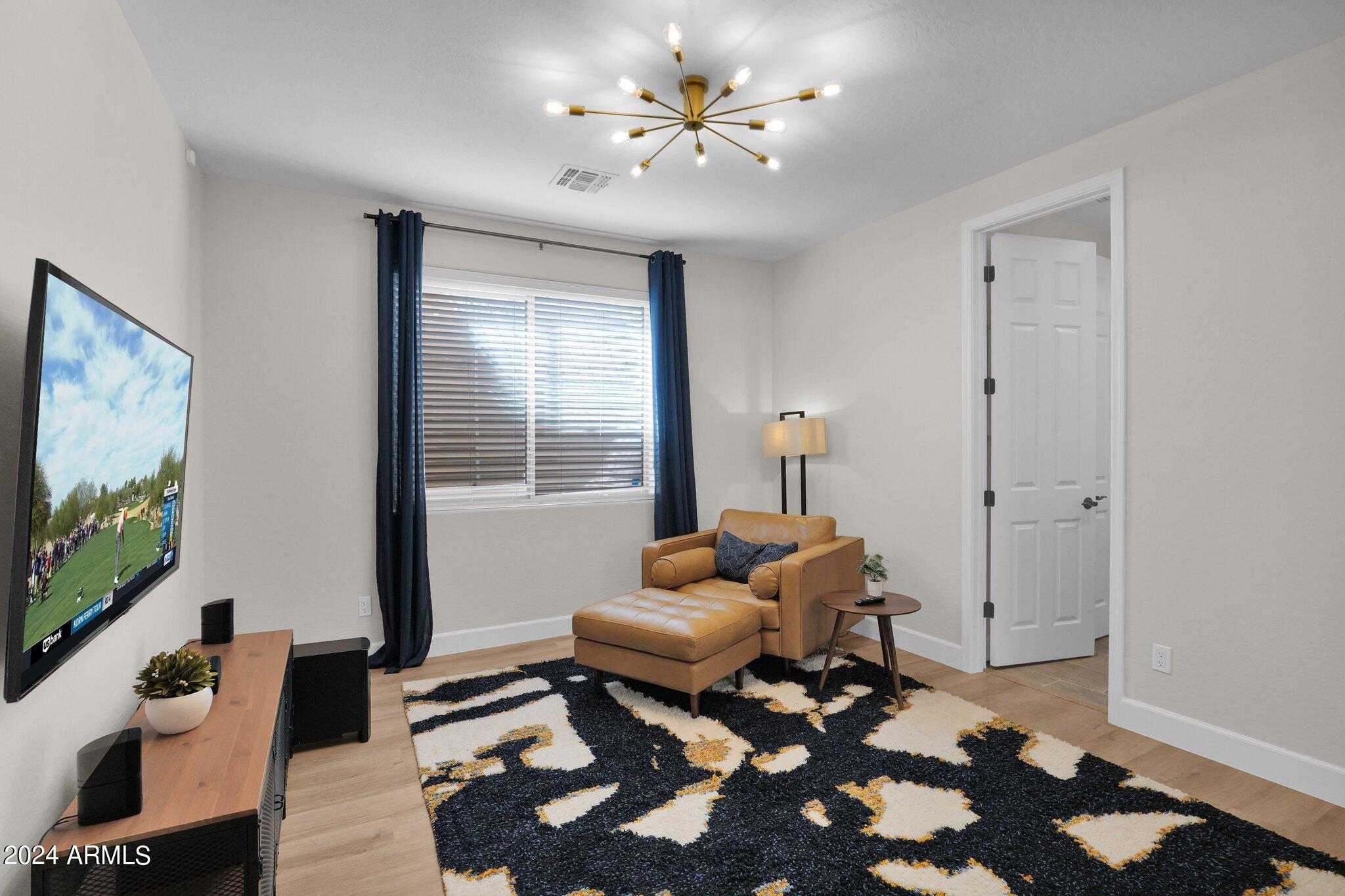 2517 South Constellation Way Gilbert, AZ 85295 - Photo 62 of 105 a living room with furniture and a flat screen tv