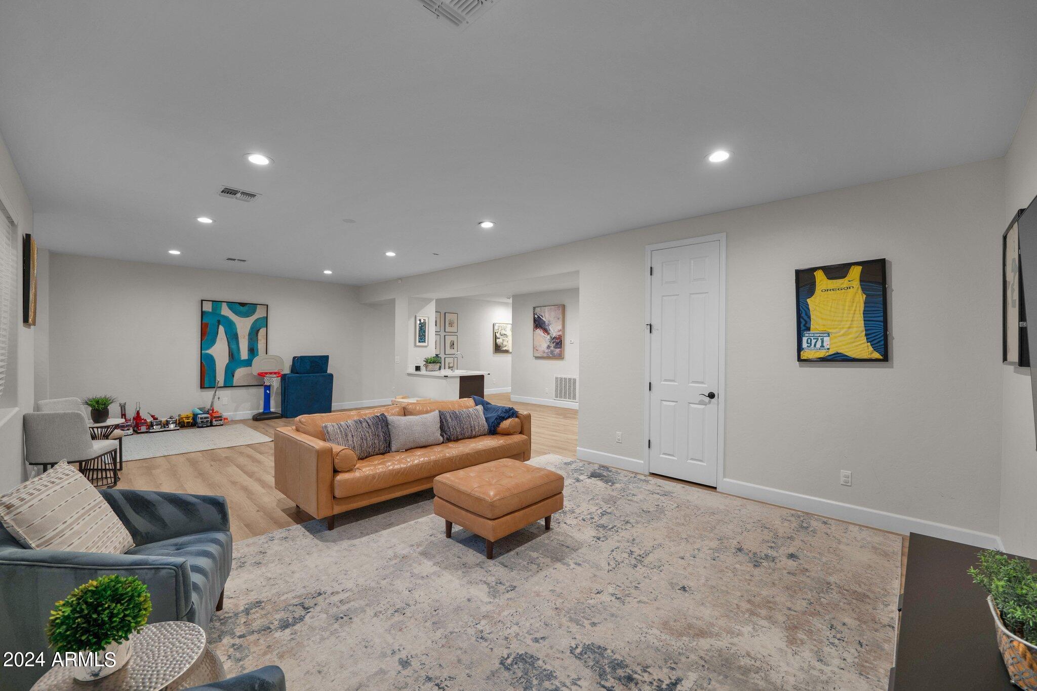 2517 South Constellation Way Gilbert, AZ 85295 - Photo 67 of 105 a living room with furniture and a wooden floor
