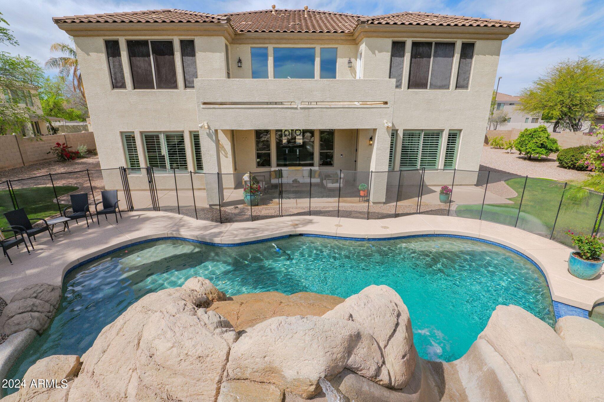 2517 South Constellation Way Gilbert, AZ 85295 - Photo 78 of 105 a front view of a house with a yard table and chairs
