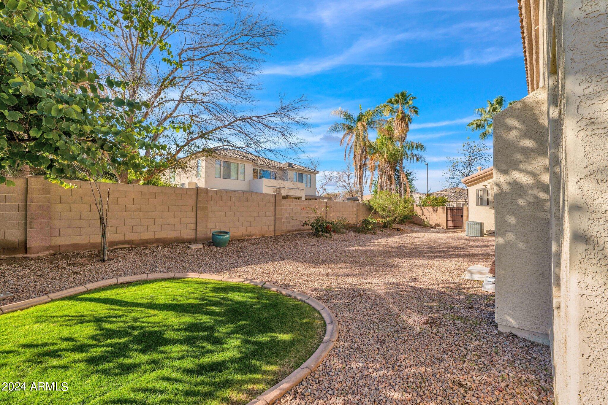 2517 South Constellation Way Gilbert, AZ 85295 - Photo 89 of 105 a backyard of a house with yard and outdoor seating
