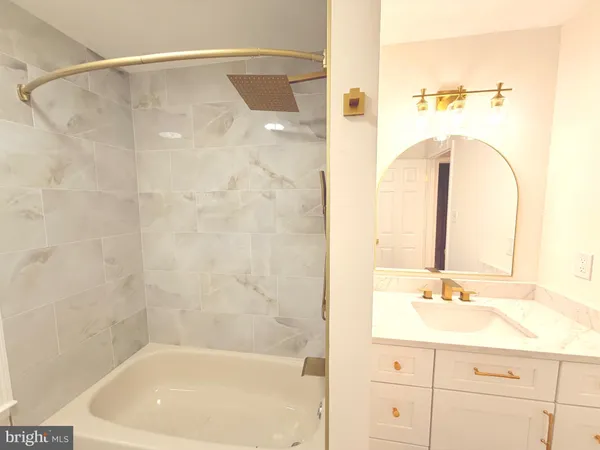 a bathroom with a bathtub and a sink