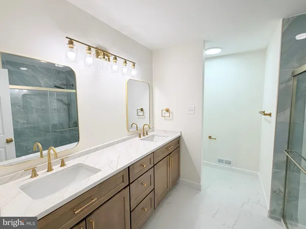 a bathroom with a sink double vanity and a mirror