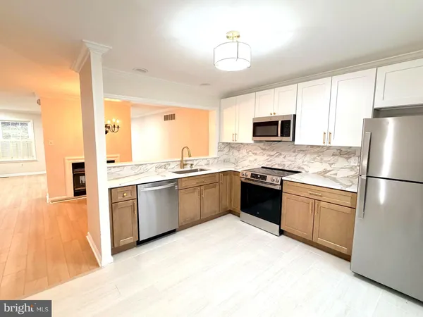 a kitchen with granite countertop a refrigerator stove top oven and sink