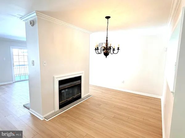 a view of a room with a fireplace and wooden floor
