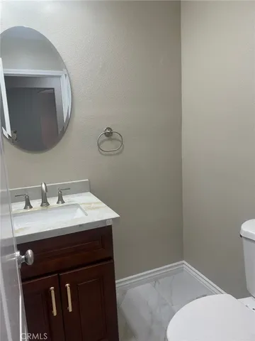 a bathroom with a sink vanity and a mirror